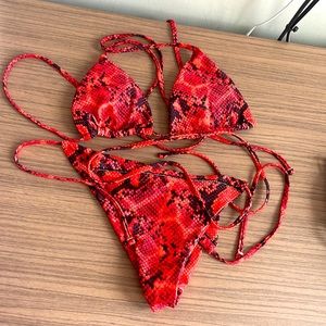 Medium red and black snake skin bathing suite.